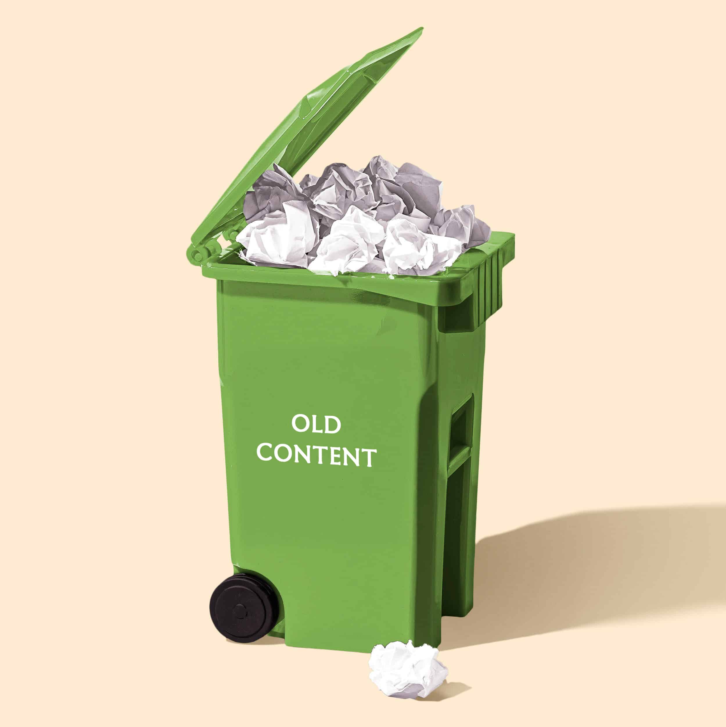 Image of green wheelie bin with "old content" printed on it and paper rubbish overflowing