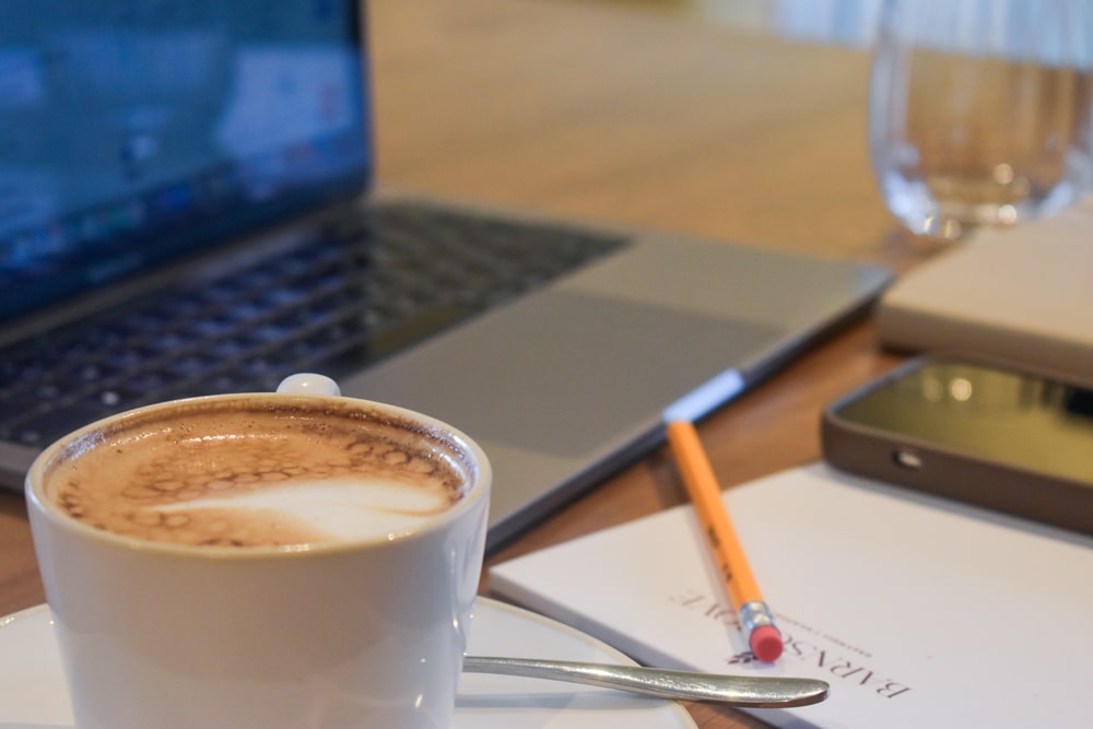 A delicious coffee in front of a laptop