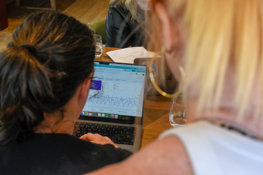 Alice on her laptop with Natalie looking over her shoulder